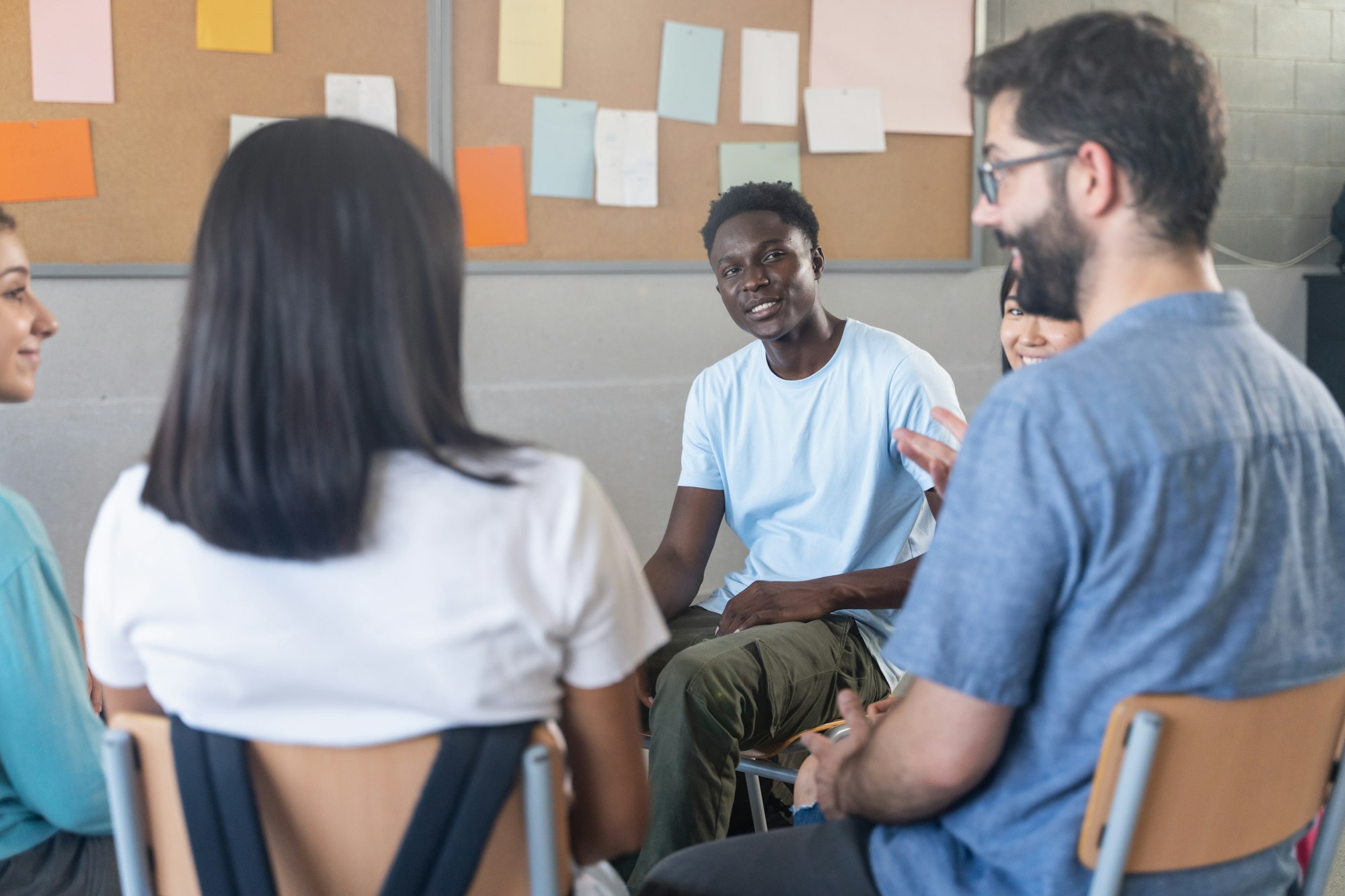 African Teenager Student talking with teacher and classmates - Group discussion in Education